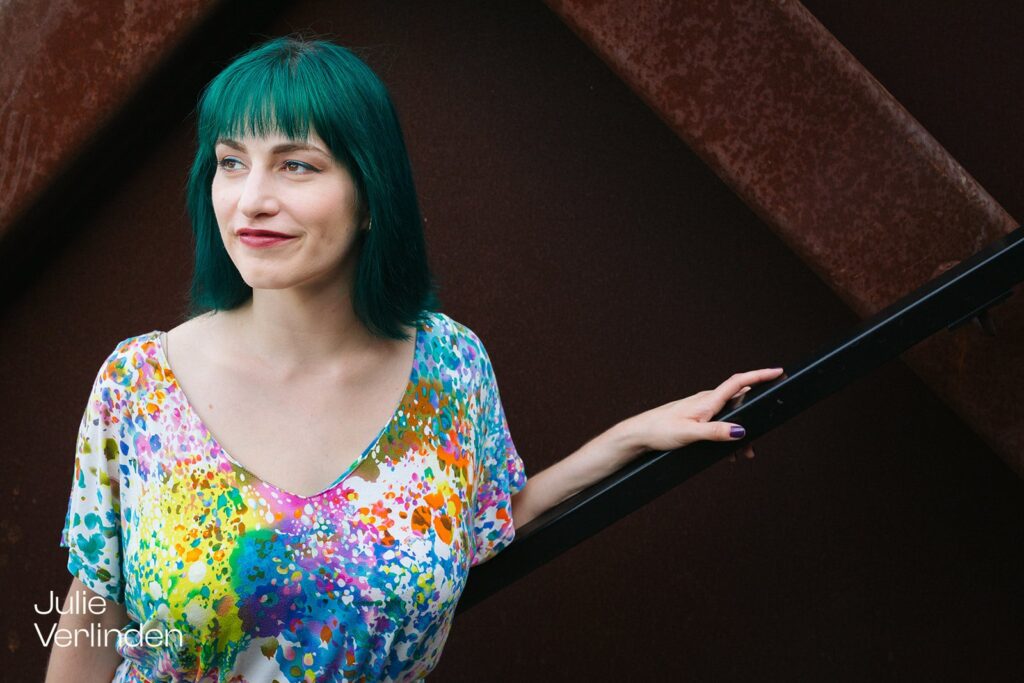 woman in colorful dress looking out with dark background