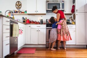 girl hugs mom in kitchen