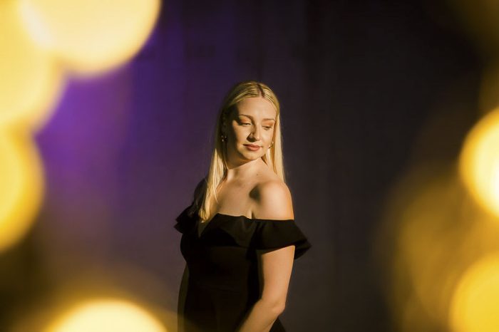 portrait-photography-134 LSU college graduate in black dress surrounded by LSU colors